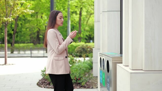 Strong woman preparing to smoke cigarette during lunch break outside modern office corporate. Confident caucasian female making decision to quit bad habit and throwing away cancer stick outdoors.