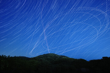 三輪山上空を飛ぶ飛行機の光跡