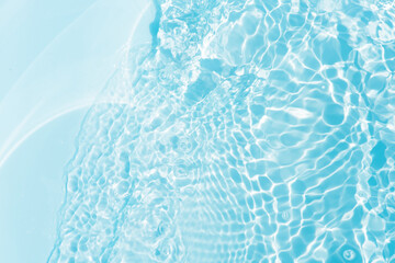 Blue water with ripples on the surface. Defocus blurred transparent blue colored clear calm water...