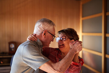 Close up of a senior couple dancing at home. Well-being and enjoying free time together.