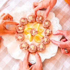 Group of people taking tuna food from dish in friendship lunch. Above vertical view. People eating together. Healthy nutrition. Appetizer in friendship. Celebration around table. Restaurant or home