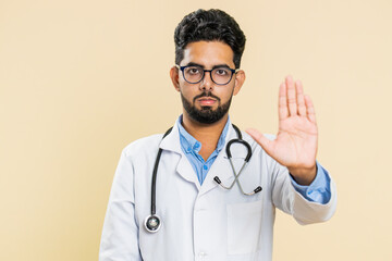 Stop, enough. Serious Indian young doctor cardiologist man say no, warning of finish, prohibited...
