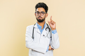 Displeased upset Indian young doctor cardiologist man reacting to unpleasant awful idea,...
