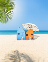 Miniature house on tropical beach, vacation and holiday accommodation, summer outdoor day light, vertical style