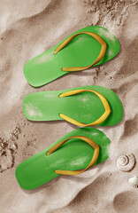 Three flip flop shoes in sand