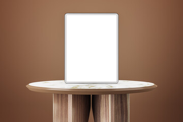 Empty wooden table with white mock up tablet on brown background. 3D Rendering.