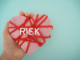 赤い毛糸を巻いたハートにriskリスクの文字