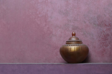 antique beautiful copper pottery jar and lid on old red cement floor and old red cement background,...