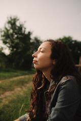 Calm woman enjoying the moment and slow life at her eco-farm. Concept green tourism, slow life, gardening, eco friendly