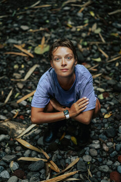 Woman traveler in a cave in the jungle after swimming in a waterfall.