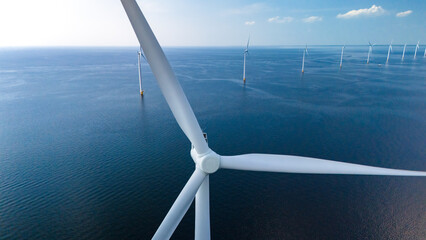 Towering windmill turbines intricately placed in the vast ocean expanse of the Netherlands...