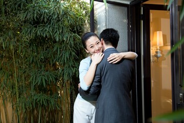 Husband and wife say goodbye at the door