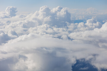 Aerial View Beauty white clouds on blue sky with soft sun light, Nature view fluffy clouds on pastel blue sky background