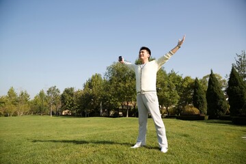 Middle-aged man doing morning exercises in the yard