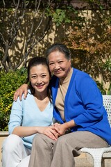 Naklejka premium Young women and elderly women in the yard