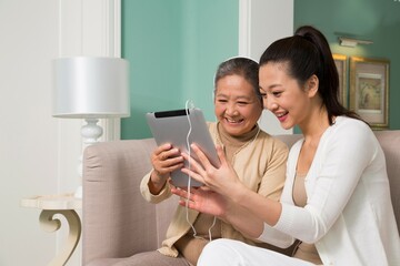 Mother and daughter in the living room to use tablet