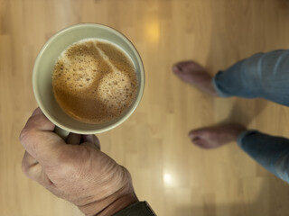 Coffee cup standing on a pallet in the morning.