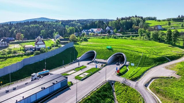 New tunnel on Zakopianka highway in Poland. The tunnel is 2 over km long and makes travel from Krakow to Zakopane, Podhale region and Slovakia much faster. Old road above. Aerial 4K panning video