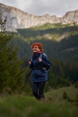 Hiker lady with backpack in the mountains - 808650959