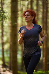 Woman trail runner in the forest - 808651303