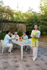 A family eat breakfast in the yard