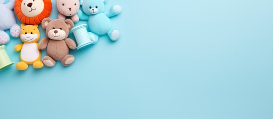 Top view of rubber baby toys for bath arranged in a flat lay style on a blue background providing ample copy space in the image