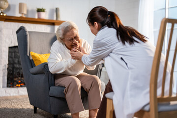 Asian caregiver nurse examine and listen to senior stress woman patient. 