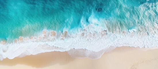 Obraz premium A stunning top view aerial image of a beach with turquoise water offers copy space for your advertising text