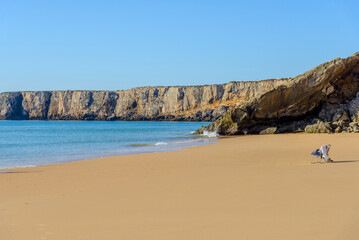 calm sandy beach on the shores of the Atlantic Ocean, famous tourist town Sagres, Portugal