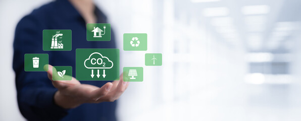 Businessman hand hold recycle symbol connection with virtual modern reduce CO2 emission concept with icons, global warming emissions carbon footprint climate change to limit global warming, energy
