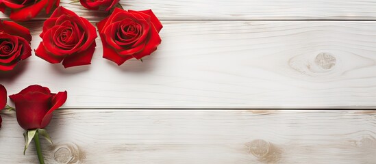 Copy space image featuring roses and red hearts arranged on a white wooden background - Powered by Adobe