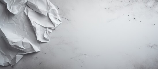 The gray background is occupied by a crumpled white paper leaving empty space for other elements in the image. Copy space image. Place for adding text and design