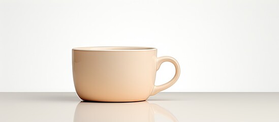 A side view of a cream colored ceramic cup is shown in a copy space image against a white background