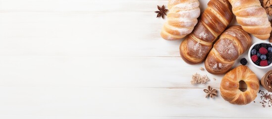 Top view of freshly baked bakery products on a white wooden background creating a holiday themed ambiance Copy space image available