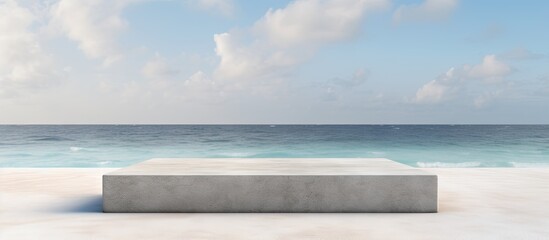 Fototapeta premium Front view of a grungy grey concrete stone platform podium for cosmetics or products set against a white beach sand background with copy space image