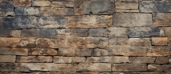 Aged stone wall with a grungy texture provides a distinctive background suitable for use as a copy space image