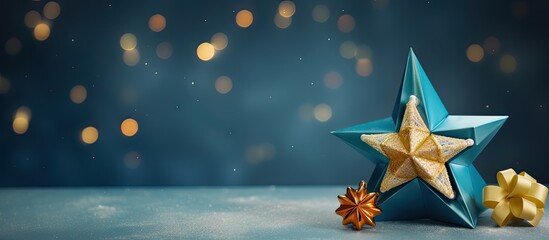 A handmade Christmas gift an origami Christmas star and a tree are arranged on a blue table background with soft lighting from overhead windows creating a beautiful capture of the subject Copy space