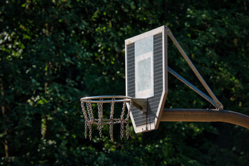 Ein Basketballkorb aus Metall in seitlicher Ansicht in einem öffentlichen Park