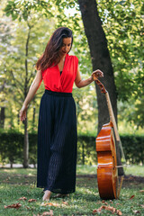Woman with cello in a park