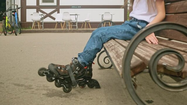 Little girl going roller skating in the park close up