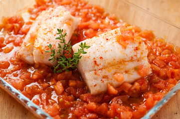 Two hake fillets with tomato sauce