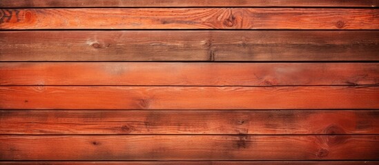 Fototapeta premium Copy space image of a rustic wooden background made from weathered boards showcasing a warm brick red orange color palette