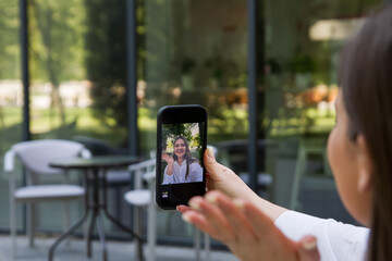 The girl takes a selfie. Hands and phone close-up