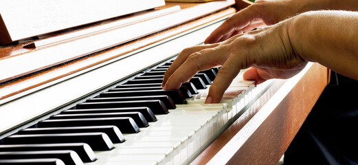 Old person playing the piano. Wrinkled hands. old musician.