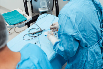 Skilled surgeon and his medical team performs precise eye surgery on an elderly patient, restoring...