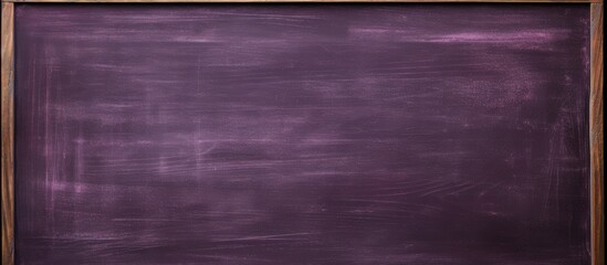 Fototapeta premium Copy space image of a purple blackboard with a blank chalkboard texture