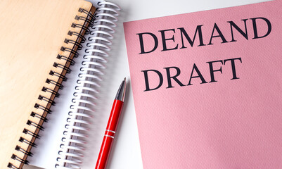 DEMAND DRAFT text on pink paper with notebooks