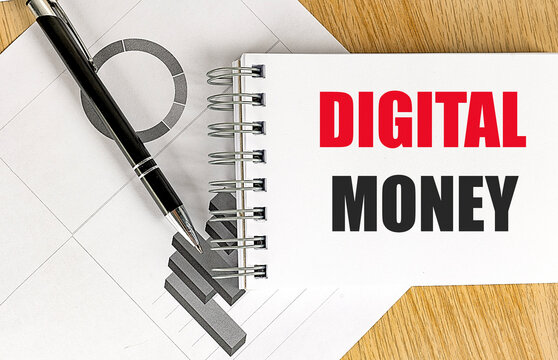DIGITAL MONEY text on notebook with chart on wooden background - Powered by Adobe