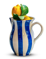 A traditional white and blue Amalfi jug and lemons. Isolate on a white background