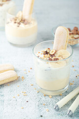 Milk mousse dessert with nuts in glasses